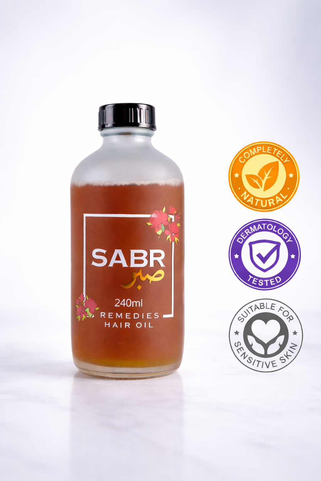 SABR hair oil bottle with certification logos on a white background